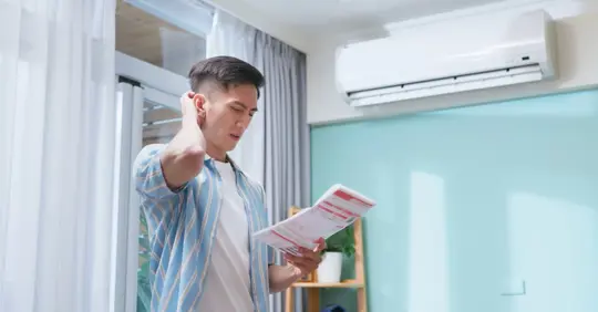 Man looking at electric bill