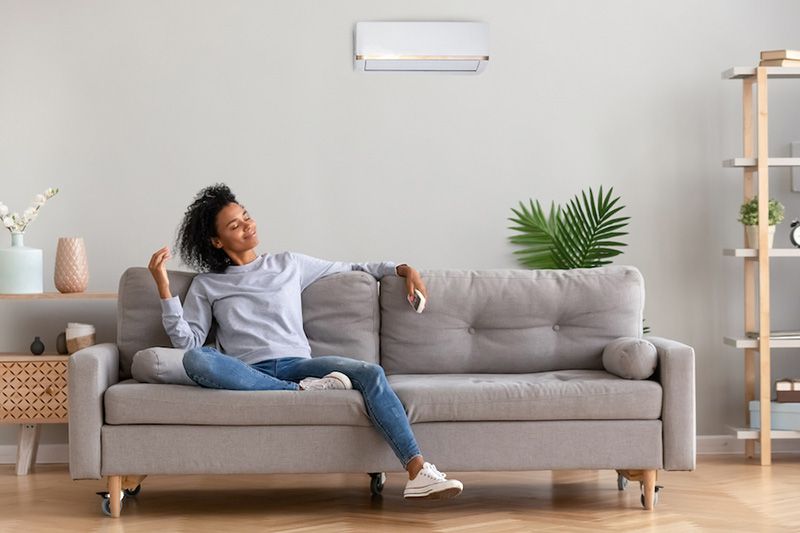 Image of someone sitting on their couch. What Accessories Can Help With My Indoor Air Quality?