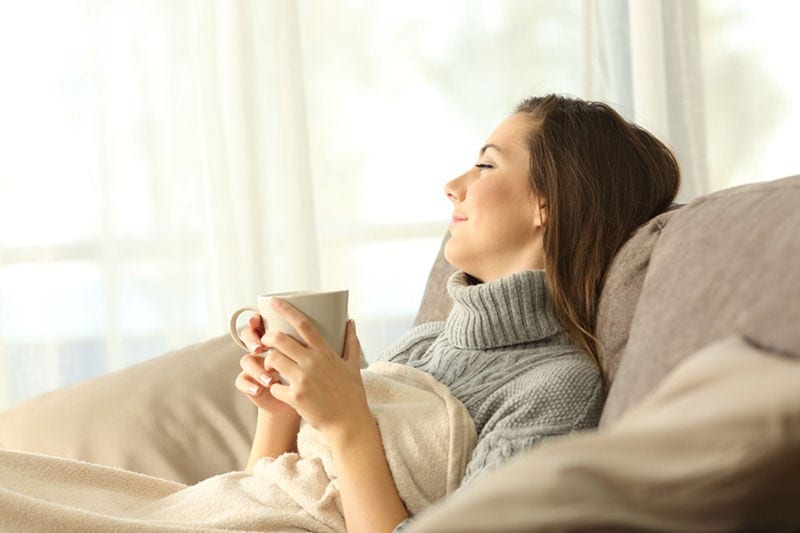 Pensive woman relaxing at home