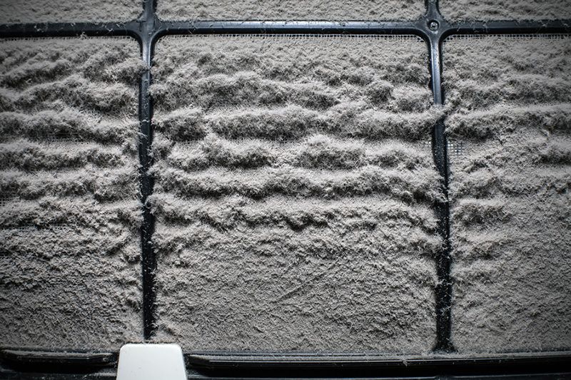 Image of a dusty air filter. 4 Reasons to Replace Your Home’s Air Filter.