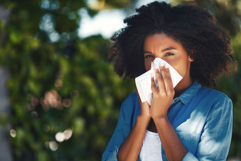 Image of person blowing nose. Does an AC Help With Allergies?